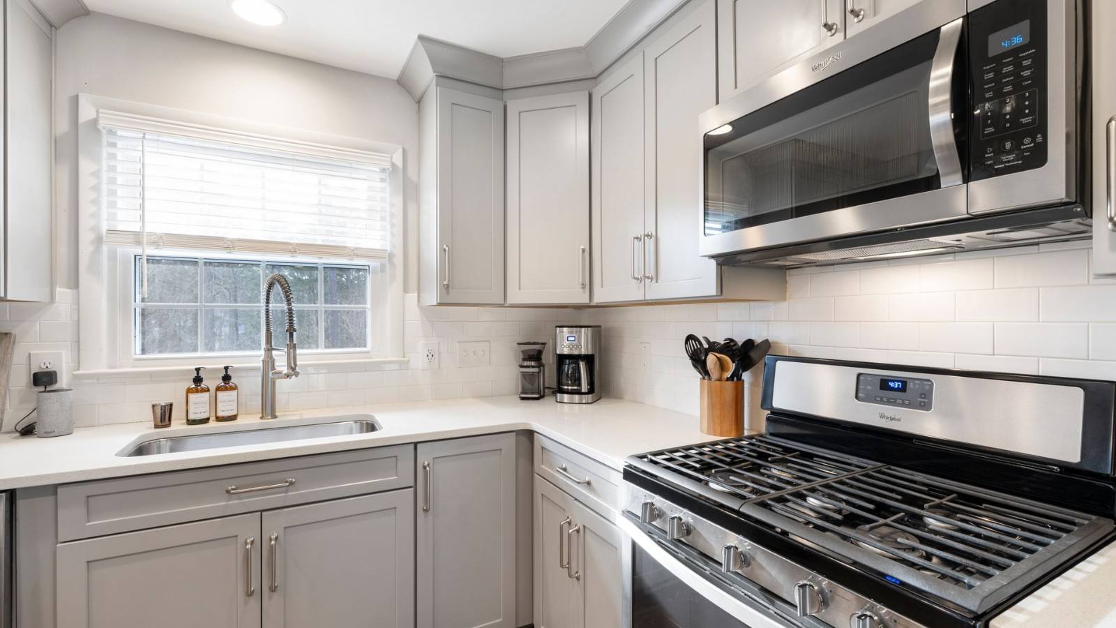 Stainless steel freestanding range in a kitchen with wood cabinets