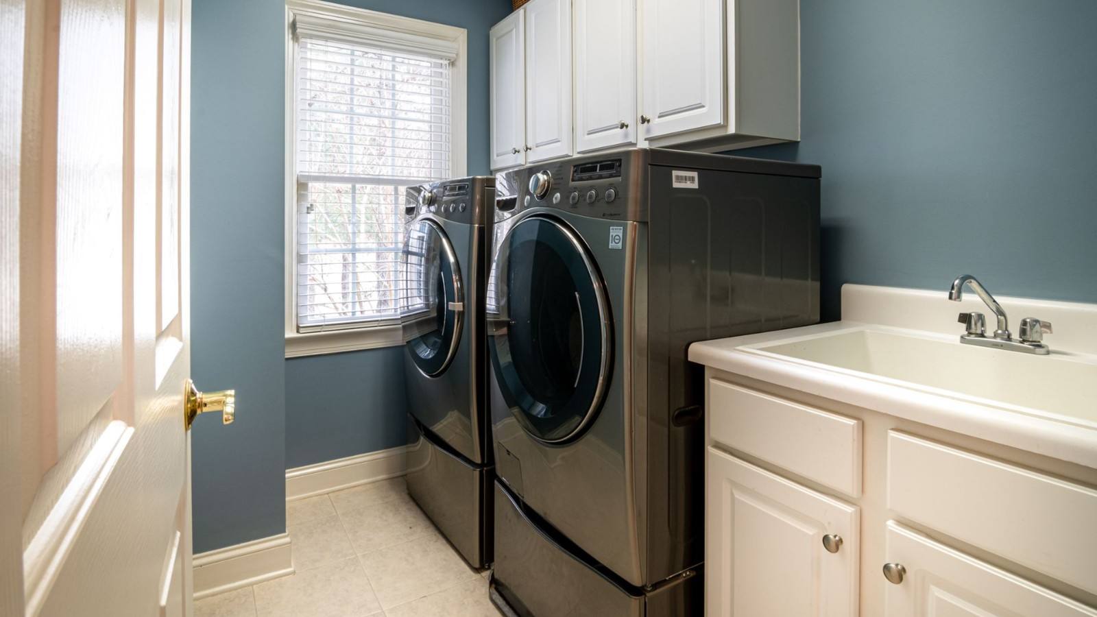 Front-load washer and matching dryer side by side in a laundry room
